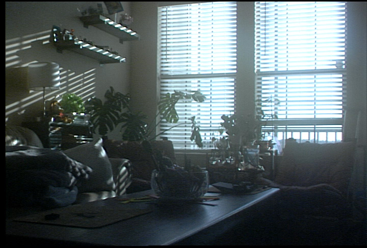 A screenshot of a dimly lit room with bright windows captured over HDMI